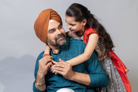 Photo for Indian sikh father and daughter having fun together studio shot , Father and daughter lifestyle concept shoot - Royalty Free Image