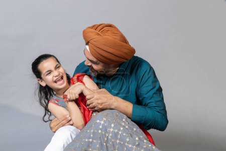 Photo for Indian sikh father and daughter having fun together studio shot , Father and daughter lifestyle concept shoot - Royalty Free Image
