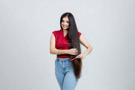 Photo for Indian Latin Girl Doing hair Brush Studio shot, Beauty and hair care concept - Royalty Free Image