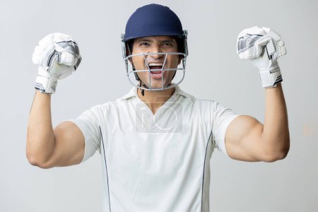 Photo for Man In cricket dress with helmet screaming in joy and anger looking towards the camera , Cricketer world cup concept - Royalty Free Image