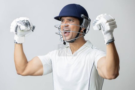 Photo for Man In cricket dress with helmet screaming in joy and anger, Cricketer world cup concept - Royalty Free Image
