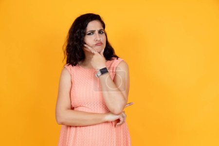 Photo for Woman with hand on chin thinking about question, pensive expression. smiling with thoughtful face. doubt concept. - Royalty Free Image