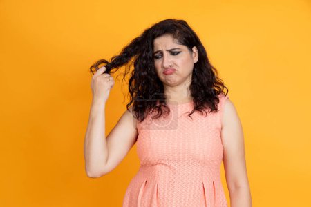 Photo for Frustrated indian female with damaged hair and worry with hair fall problem - Royalty Free Image