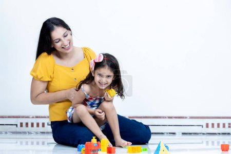 Photo for Playful mother and daughter having fun with each other at home,Indian mother and daughter having fun together - Royalty Free Image