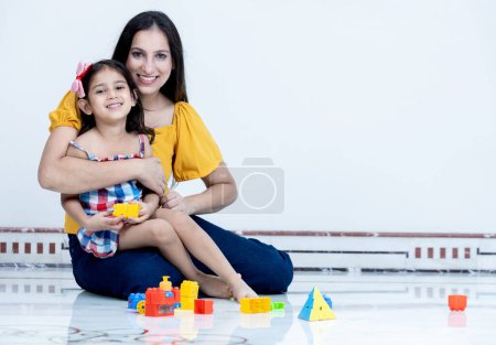 Photo for Portrait of playful Indian mother and daughter having fun together - Royalty Free Image