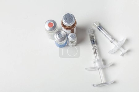 Photo for Glass medicine bottle and botox, hyaluronic, collagen or syringe. with space for text - Royalty Free Image