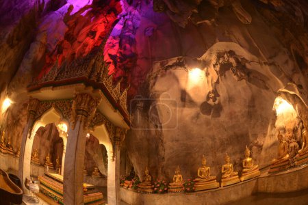 Buddha's footprint and Buddha statues in various postures Enshrined in the famous Tham Khao Yoi Temple. And there are beautiful stalagmites and stalactites. Located at Petchaburi Province in Thailand.