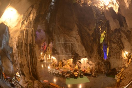 Buddha's footprint and Buddha statues in various postures Enshrined in the famous Tham Khao Yoi Temple. And there are beautiful stalagmites and stalactites. Located at Petchaburi Province in Thailand.
