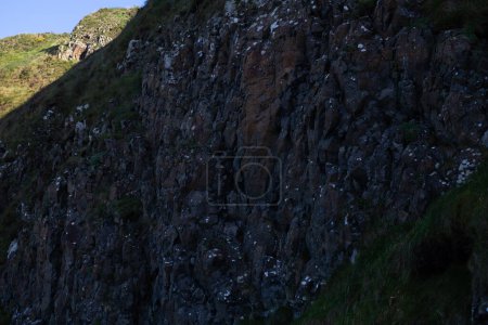 A close-up view of the rugged rocky cliff face at Giants Causeway in Northern Ireland.
