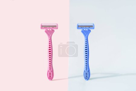 Photo for Razors with gender colors against pink and blue background. - Royalty Free Image