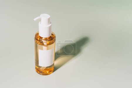 Photo for Facial care hydrophilic oil on green background under hard light. - Royalty Free Image