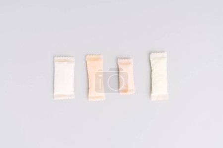 Assorted sachets of non-smoking tobacco product with different flavors on a light background.