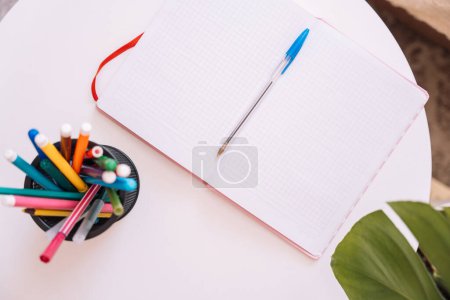 Notepad with stationery on the table.