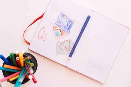 Childrens drawing in a notebook drawn with a felt-tip pen.