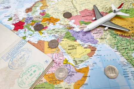 Foto de Dubai, UAE - February 19 2018: Composition made of a world map focused on Middle East with on it, some UAE dirham coins as well as an opened passport displaying entry and exit stamps. All the objects are arranged around United Arab Emirates on the ma - Imagen libre de derechos