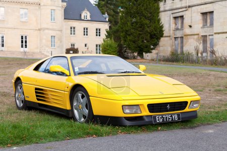 Photo for Lamorlaye, France -  September 06 2020: Yellow Ferrari 348 (Type F119), a mid-engine V8-powered 2-seat sports car produced by Italian automaker Ferrari. - Royalty Free Image