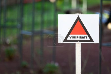 Photo for Triangular sign outside a school for the Vigipirate plan, the France's national security alert system against terrorist threats. - Royalty Free Image