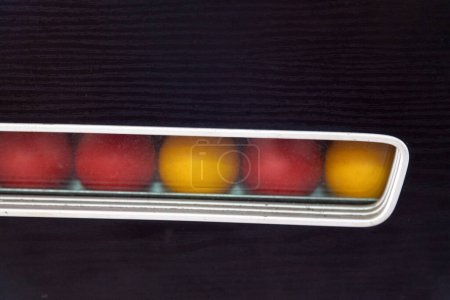 Photo for Row of red and yellow balls from a Blackball game. - Royalty Free Image