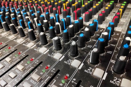 Foto de Close-up on the rows of buttons from a mixing board. - Imagen libre de derechos