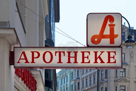 Photo for Austrian pharmacy displaying the traditional pharmacy sign above a second sign "Apotheke", meaning in English "Pharmacy". - Royalty Free Image