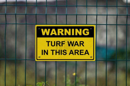 Photo for Red an white warning sign on a fence stating in "Warning - Turf war in this area" with a blank space underneath. - Royalty Free Image
