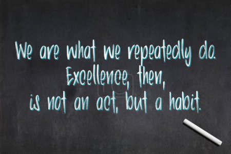 Photo for Blackboard with a quote from Aristotle drawn in the middle saying "We are what we repeatedly do. Excellence, then, is not an act, but a habit.". - Royalty Free Image