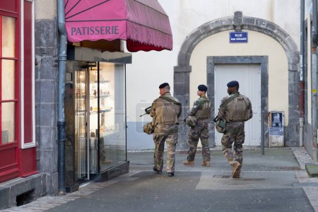 Photo for Clermont-Ferrand, France - December 11 2019: French soldiers patrolling near in the city center in order to spot any suspicious activities. - Royalty Free Image