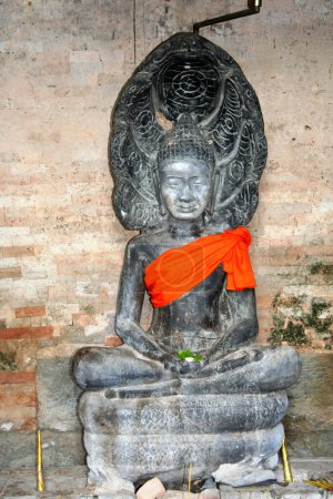 Photo for Buddha statue at the East Mebon, a 10th Century temple at Angkor, Cambodia. Built during the reign of King Rajendravarman, it stands on what was an artificial island at the center of the now dry East Baray reservoir. - Royalty Free Image