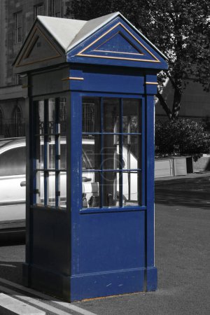 Photo for Color isolated blue sentry box in London on a black and white background. - Royalty Free Image