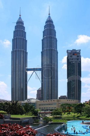Photo for Kuala Lumpur, Malaysia - August 24 2007: The Petronas Towers and the Maxis Tower in Kuala Lumpur viewed from the park. - Royalty Free Image