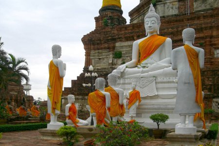 Photo for Group of statues buddhist monks gathered around Buddha to worship him at Wat Yai Chaimongkhon in Ayuthaya. - Royalty Free Image