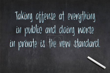 Photo for Blackboard with a quote saying "Taking offense at everything in public and doing worse in private is the new standard.", drawn in the middle. - Royalty Free Image