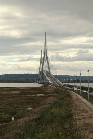 Photo for Honfleur, France - October 15 2012: The "Pont de Normandie" is a 7,032 ft length cable-stayed road bridge that spans the river Seine linking Le Havre to Honfleur in Normandy. - Royalty Free Image