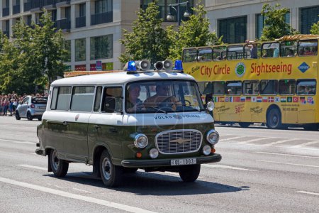 Photo for Berlin, Germany - June 01 2019: Couple driving an old police van (Volks Polizei). The Deutsche Volkspolizei (English: German People's Police) was the national police force of the German Democratic Republic (East Germany) from 1945 to 1990. - Royalty Free Image