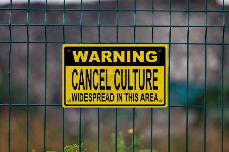 Téléchargez les photos : Panneau d'avertissement jaune et noir sur une clôture indiquant dans "Avertissement Annuler la culture répandue dans cette région". - en image libre de droit