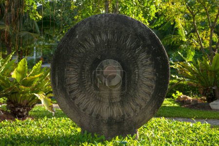 Sculpture of a Dharma Wheel in stone in Nakhon Si Thammarat, Thailand.