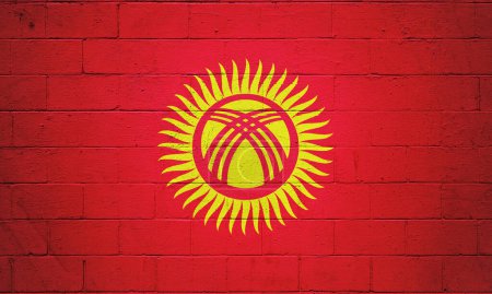 Bandera de Kirguistán pintada en una pared de bloques de cemento.