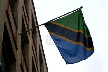 Photo for Flag of Tanzania waving above a building main entrance. - Royalty Free Image