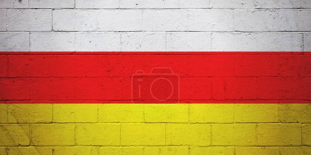 Flag of South Ossetia painted on a cinder block wall.
