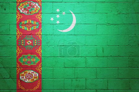 Flag of Turkmenistan painted on a cinder block wall.
