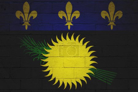 Flag of Guadeloupe painted on a cinder block wall.
