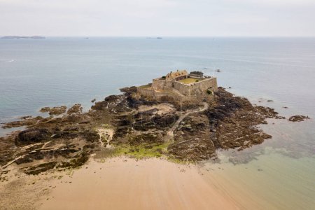 Aerial view of the Fort National, a vast 17th-century granite fortress, set on an outcrop only accessible at low tide in Saint-Malo, Brittany.