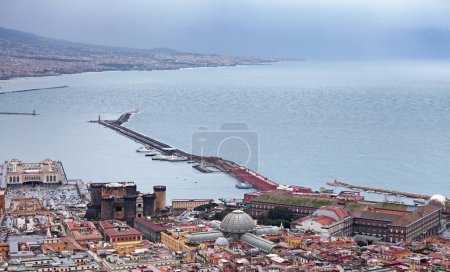 Aerial view of Naples with many landmarks, such as, the Castel Nuovo, the Galleria Umberto I, the Cruise Terminal and the port.