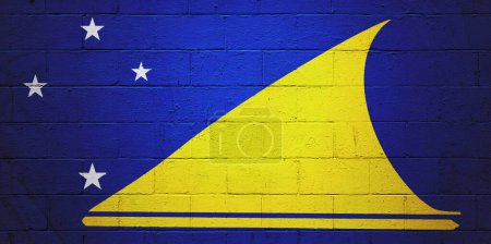 Flag of Tokelau painted on a cinder block wall.
