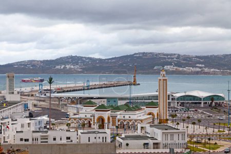 Photo for Tangier, Morocco - January 23 2019:  Aerial view of the Port Mosque and the port with a ferry leaving it to Tarifa. - Royalty Free Image