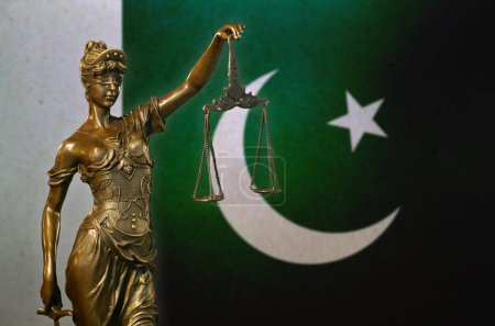 Photo for Close-up of a small bronze statuette of Lady Justice before a flag of Pakistan. - Royalty Free Image