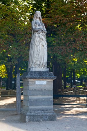 Statue of Sainte Genevieve, Patron Saint of Paris (423 to 512) in the Jardin du Luxembourg in Paris. This sculpture in part of a series of white marble statues of women that flank the the central gardens and the pond.