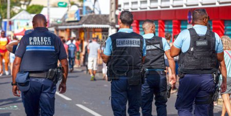 Photo for Saint-Gilles les bains, La Reunion - June 25 2017: Joint patrol between the gendarmerie and the police municipale during the carnival of the Grand Boucan. - Royalty Free Image