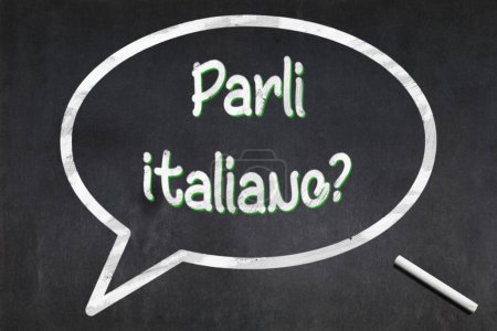 Blackboard with a bubble drawn in the middle with the short phrase "Parli italiano?", meaning "Do you speak Italian ?".