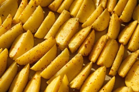 Rustic French fries, cut into thicker slices, served with herbs and salt. Background.